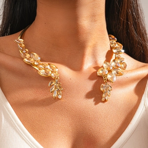 Detailed view of vintage gold choker necklace with amber crystals on model's neckline