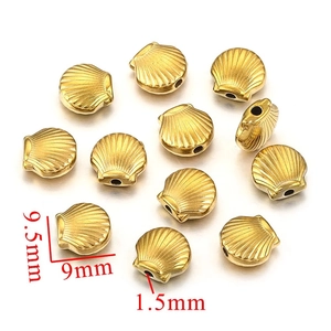 Macro shot of 9.5mm gold stainless steel shell beads showing dimensions and 1.5mm hole size