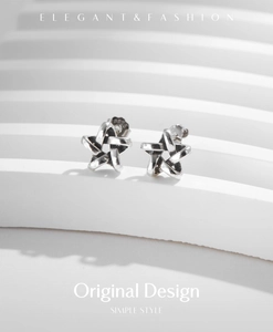 Macro shot of S925 sterling silver hollow star earrings with vintage antique finish