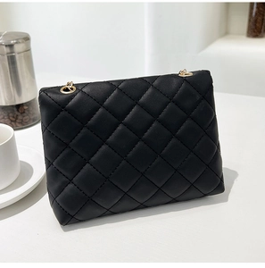Close-up of black quilted PU leather crossbody bag with elegant gold chain strap