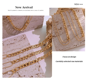 Detail of 18K gold-plated double-layer necklace and bead chain on a stone texture