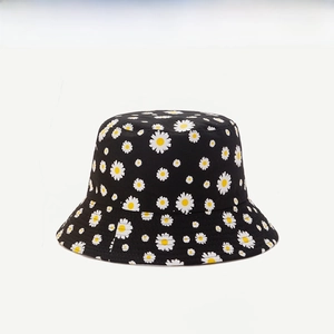 Close-up of white daisy floral embroidery on black canvas reversible bucket hat