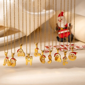 Detailed close-up of Santa Claus letter pendants with festive red and white oil dripping