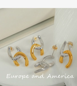 Detailed view of interconnected U-shape earrings in polished gold and silver tone finish