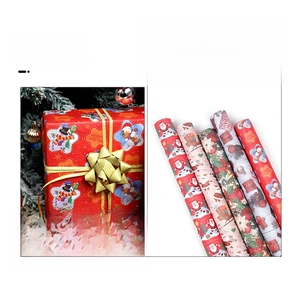 Macro detail of Christmas wrapping paper rolls with Santa Claus and snowman festive patterns