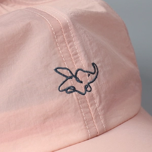 Close-up of elephant embroidery on lightweight pink quick-dry fabric baseball cap