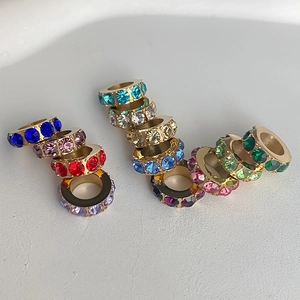 Detailed view of gold-plated stainless steel large-hole spacer beads with various colorful rhinestones
