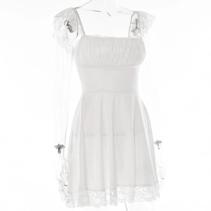 Detail shot of the delicate white lace trim and ruched fabric on the sexy mini dress