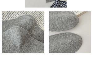 Macro detail of high-quality grey knitted cotton sock showing precise heel and toe stitching