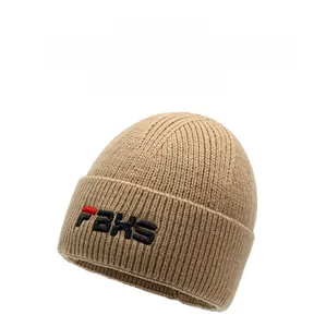 Close-up of khaki ribbed knit beanie with embroidered letters for winter warmth
