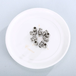Cylindrical stainless steel ripple spacer beads for DIY jewelry making on ceramic tray