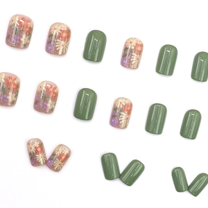 Short round press-on nails with fresh floral patterns and glossy olive green finish