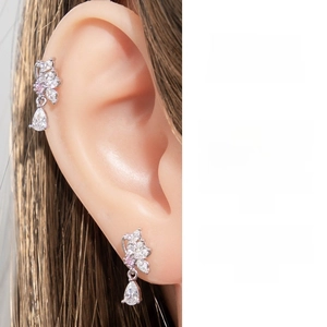 Detailed view of silver butterfly ear stud with pink zircon and water drop pendant