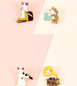 Detail set of four cute enamel cat pins featuring bread, beer, golf, and music themes