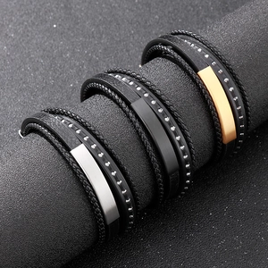 Three-piece layered braided leather and stainless steel bracelets for men shown on display