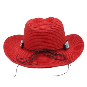 Front view of a vibrant red woven cowboy straw hat with beaded ethnic decoration
