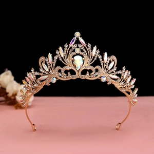 Macro detail of luxury gold Baroque crown featuring colorful crystals and bright diamonds