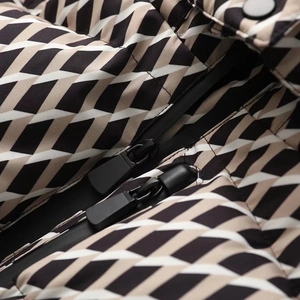 Detail of premium warm ski jacket with geometric patchwork and double black zipper closure