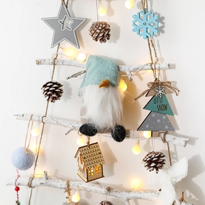 DIY tiered wooden branch Christmas tree wall hanging with warm LED lights and ornaments