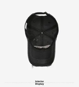 Internal structure of distressed black cotton baseball cap showing lining and wash tag