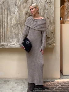 Detail of off-shoulder knitted dress with elegant vertical ribbed texture and gray wool finish