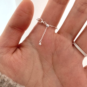 Detailed view of adjustable 925 sterling silver chain ring with sliding bead clasp