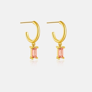 Macro detail of S925 silver earrings with rectangular orange-pink gemstones in gold finish