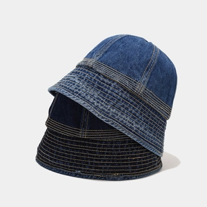 Vertical stack of denim bucket hats in light, medium, and dark blue wash tones