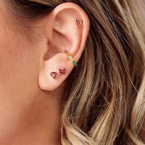 Detailed close-up of S925 sterling silver ruby and rainbow zircon stud earring set