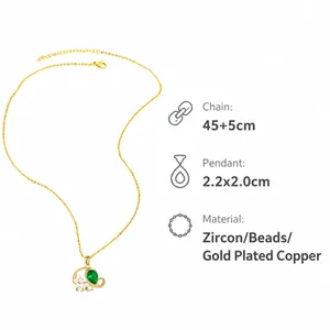 Detailed view of elephant pendant with green zircon and pearl on gold plated chain