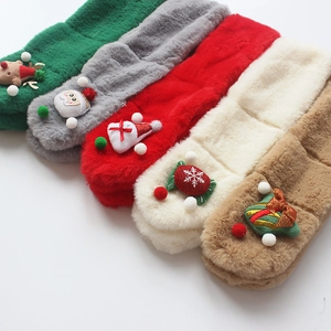 Detail view of five plush Christmas scarves with cartoon Santa and reindeer decorations