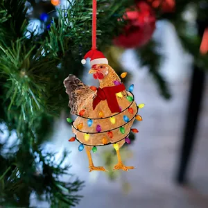 Funny Christmas chicken ornament with red scarf and hat hanging on a festive tree branch