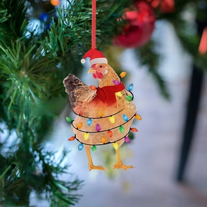 Funny Christmas chicken ornament with red scarf and hat hanging on a festive tree branch