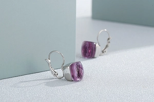 Macro shot of square purple crystal earrings with polished silver leverback hooks