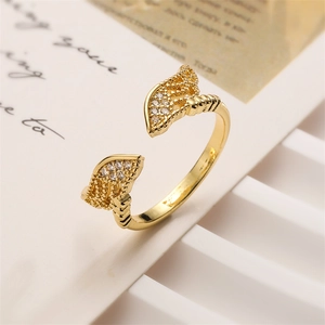 Close-up of adjustable gold-plated ring with leaf motifs and shimmering zircon stones