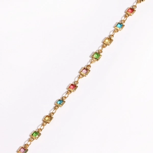 Square colored zircon gold bracelet with pink blue yellow and green stones on white background