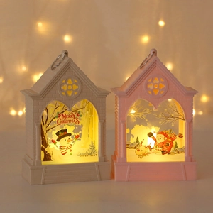 Close-up of LED Christmas lanterns with snowman and Santa silhouettes in warm light