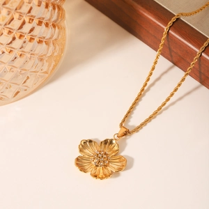 French luxury gold twist chain necklace with sparkling flower pendant and crystal detail