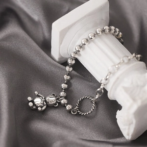 Silver bear pendant beaded bracelet with OT toggle clasp on decorative stone
