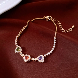 Nahaufnahme des Herz-Edelsteinarmbands in Gold auf elegantem rotem Seidenhintergrund