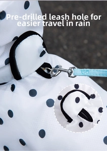 Detail view of pet raincoat showing the waterproof leash hole with bear dot pattern