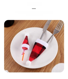 Mini Christmas buffalo plaid hats used as festive cutlery holders and lollipop covers
