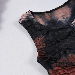 Detail shot of tie-dye pleated mesh fabric showing intricate texture and layered mesh patterns