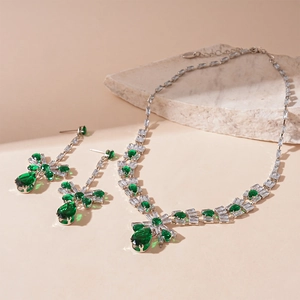 Detail of luxury emerald teardrop pendant necklace and matching earrings set