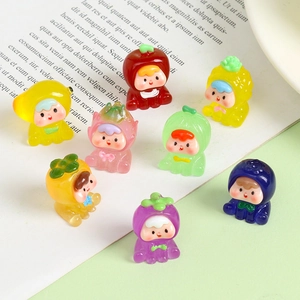 Close-up of eight luminous resin fruit figurines including apple and strawberry shapes