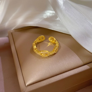 Gold open ring with pig nose design and micro-pave zircons on a warm jewelry box