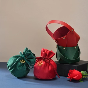 Christmas gift boxes with red and green velvet drawstring bags and leather handle baskets