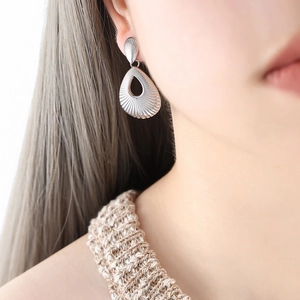 Vintage hollow waterdrop earrings in silver finish with radial textured metal pattern