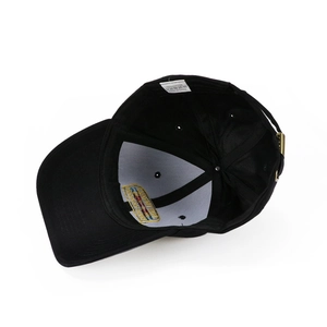 Internal view of black cotton baseball cap showing stitching and adjustable metal strap