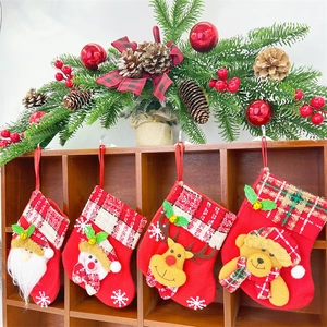 Detail of red Christmas stockings with 3D Santa, Snowman, Reindeer, and Bear ornaments